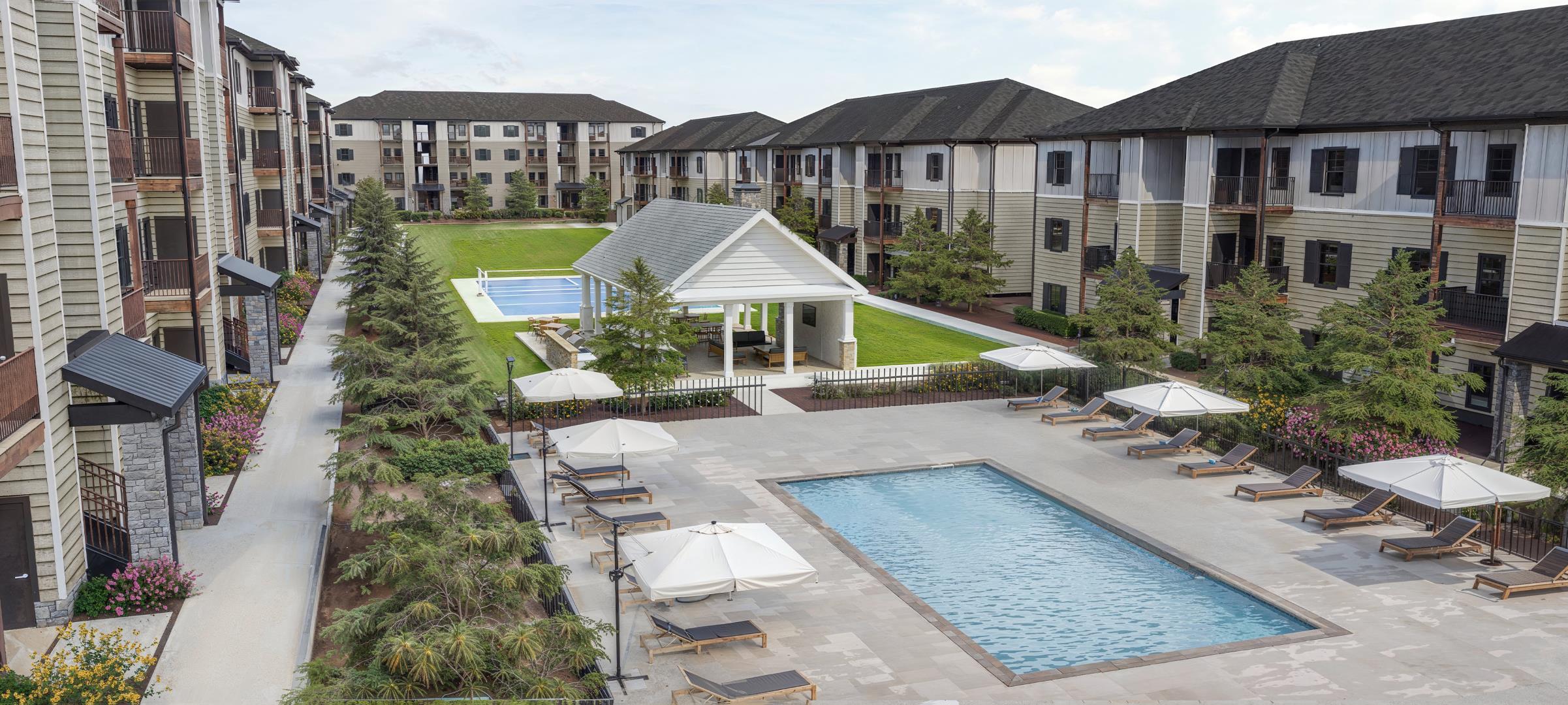 Taylors, SC, Apartments Near Furman University - NorthBrook - Courtyard with Lush Landscaping, Exclusive Pickleball Court, and Gated Saltwater Pool